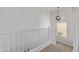 Upstairs landing with a bright window, stylish light fixture, white bannister, and carpeted flooring at 4615 E Calistoga Dr, Gilbert, AZ 85297