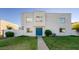 Charming two-story townhouse featuring a well-kept lawn and a bright blue front door at 5243 N 42Nd Ln, Phoenix, AZ 85019