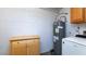 Functional utility room with a water heater and ample space for laundry or storage at 5243 N 42Nd Ln, Phoenix, AZ 85019
