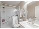 Bright bathroom featuring a quartz countertop sink, a white tiled shower, and grab bar at 10417 W Pioneer St, Tolleson, AZ 85353