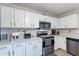Updated kitchen featuring ample storage with modern appliances and bright countertops at 10417 W Pioneer St, Tolleson, AZ 85353