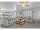 Bright living room with a large sectional and seamless flow into the adjacent kitchen area at 10417 W Pioneer St, Tolleson, AZ 85353