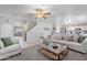 Spacious living area with neutral tones, opening to the kitchen with a view to the stairs at 10417 W Pioneer St, Tolleson, AZ 85353