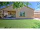 Lovely backyard featuring artificial turf and a covered patio, creating a perfect outdoor oasis at 11060 E Sorpresa Ave, Mesa, AZ 85212