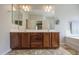 Bright bathroom with double sinks, large mirror, tile flooring, and separate tub area at 11060 E Sorpresa Ave, Mesa, AZ 85212