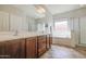 Bathroom featuring double sink vanity, soaking tub, and a separate glass door shower at 11060 E Sorpresa Ave, Mesa, AZ 85212