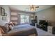 Spacious bedroom with plush carpet, natural light, ceiling fan and striped accent wall at 11060 E Sorpresa Ave, Mesa, AZ 85212