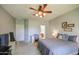 Inviting bedroom with natural light, gray walls, and an attached bathroom and desk area at 11060 E Sorpresa Ave, Mesa, AZ 85212