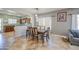 Dining area featuring tile floors, modern lighting, and seamless transition to the kitchen at 11060 E Sorpresa Ave, Mesa, AZ 85212