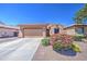 Charming single-story home with a well-manicured front yard and a two-car garage at 11060 E Sorpresa Ave, Mesa, AZ 85212