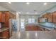 Well-lit kitchen featuring ample cabinet space, stainless steel appliances, and easy access to the backyard at 11060 E Sorpresa Ave, Mesa, AZ 85212
