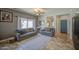 Comfortable living room with tile floors, neutral paint, and open access to other rooms at 11060 E Sorpresa Ave, Mesa, AZ 85212