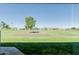 Serene view of a spacious backyard overlooking a lush green golf course, providing a tranquil setting at 11250 E Kilarea Ave # 276, Mesa, AZ 85209