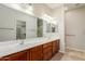Bathroom featuring double sinks, spacious mirror, and plenty of lighting at 11250 E Kilarea Ave # 276, Mesa, AZ 85209