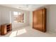 This bedroom features neutral walls, carpet floors, large window, a ceiling fan, and a convenient murphy bed at 11250 E Kilarea Ave # 276, Mesa, AZ 85209