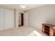 This bedroom features carpet floors, a ceiling fan, a closet with white doors, and a connecting doorway at 11250 E Kilarea Ave # 276, Mesa, AZ 85209