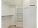 Walk-in closet featuring built-in shelving, racks, and carpeted floors at 11250 E Kilarea Ave # 276, Mesa, AZ 85209