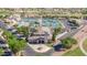 Aerial view of a clubhouse with tennis courts and lush landscaping in a vibrant community at 11250 E Kilarea Ave # 276, Mesa, AZ 85209