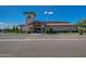 Exterior of the community clubhouse features ample parking and lush landscaping at 11250 E Kilarea Ave # 276, Mesa, AZ 85209