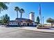 Community building showcasing architectural details, lush landscaping, and American flag at 11250 E Kilarea Ave # 276, Mesa, AZ 85209