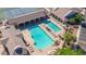 Aerial view highlighting the pool area with lounge chairs, umbrellas, and covered seating at 11250 E Kilarea Ave # 276, Mesa, AZ 85209