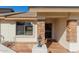 Inviting front entrance with stone accents, a security screen door, and a stylish outdoor lantern at 11250 E Kilarea Ave # 276, Mesa, AZ 85209