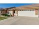 Inviting front exterior of a home with a spacious driveway, neat landscaping, and a welcoming entrance at 11250 E Kilarea Ave # 276, Mesa, AZ 85209