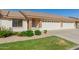 Attractive home exterior with a two-car garage, lush landscaping, and a well-maintained lawn, creating curb appeal at 11250 E Kilarea Ave # 276, Mesa, AZ 85209