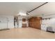 Large garage with painted floors, utility sink, and built in wood cabinets for storage at 11250 E Kilarea Ave # 276, Mesa, AZ 85209