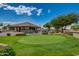 Expansive view of golf course from putting green surrounded by lush green grass and golf carts at 11250 E Kilarea Ave # 276, Mesa, AZ 85209