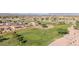 Aerial view of golf course with lush green grass and mountain views in the background at 11250 E Kilarea Ave # 276, Mesa, AZ 85209