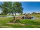 Picturesque golf course featuring a rock waterfall, blue pond, and mature trees for a serene atmosphere at 11250 E Kilarea Ave # 276, Mesa, AZ 85209