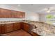 Spacious kitchen featuring granite countertops, stainless steel appliances, and wood cabinetry at 11250 E Kilarea Ave # 276, Mesa, AZ 85209