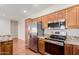 Kitchen with stainless steel appliances including refrigerator, oven, and microwave, with granite countertops at 11250 E Kilarea Ave # 276, Mesa, AZ 85209