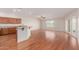 Comfortable living space with hardwood floors, a ceiling fan, and a seamless transition to the kitchen area at 11250 E Kilarea Ave # 276, Mesa, AZ 85209