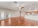 Open-concept living area with hardwood floors, a ceiling fan, and a view into the kitchen, creating a spacious atmosphere at 11250 E Kilarea Ave # 276, Mesa, AZ 85209