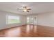 Bright living room with hardwood floors, a ceiling fan, and large windows offering a scenic view at 11250 E Kilarea Ave # 276, Mesa, AZ 85209