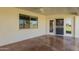 Covered patio features stained concrete floors, a screen door, and views of the community greenspace at 11250 E Kilarea Ave # 276, Mesa, AZ 85209