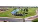 Aerial view featuring a picturesque pond with a waterfall and surrounding lush landscaping at 11250 E Kilarea Ave # 276, Mesa, AZ 85209