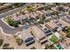 This aerial view showcases a neighborhood with well-maintained homes and solar panels at 13434 W Rovey Ave, Litchfield Park, AZ 85340