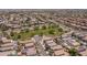 Overhead shot of a neighborhood, showing homes near a green space and roadways at 13434 W Rovey Ave, Litchfield Park, AZ 85340
