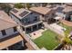 Aerial view of a home with a backyard putting green, patio, and solar panels at 13434 W Rovey Ave, Litchfield Park, AZ 85340