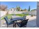 Backyard with a dining table, a synthetic putting green, and a trampoline at 13434 W Rovey Ave, Litchfield Park, AZ 85340