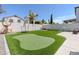 Backyard featuring a synthetic putting green, a trampoline, and a basketball hoop at 13434 W Rovey Ave, Litchfield Park, AZ 85340
