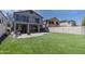 Expansive backyard featuring lush synthetic grass, a patio, and a basketball hoop at 13434 W Rovey Ave, Litchfield Park, AZ 85340