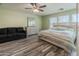 Bedroom with a queen bed, dresser, lounge seating, and natural light at 13434 W Rovey Ave, Litchfield Park, AZ 85340