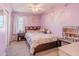Cozy bedroom with soft lighting, floral bedding, and ample space at 13434 W Rovey Ave, Litchfield Park, AZ 85340