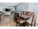 Open dining room with tile floors, a wood table, and natural light at 13434 W Rovey Ave, Litchfield Park, AZ 85340
