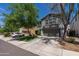 Two-story gray home featuring well-maintained landscaping, a spacious driveway, and a two-car garage at 13434 W Rovey Ave, Litchfield Park, AZ 85340
