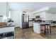 Open concept kitchen with stainless steel appliances and breakfast bar at 13434 W Rovey Ave, Litchfield Park, AZ 85340